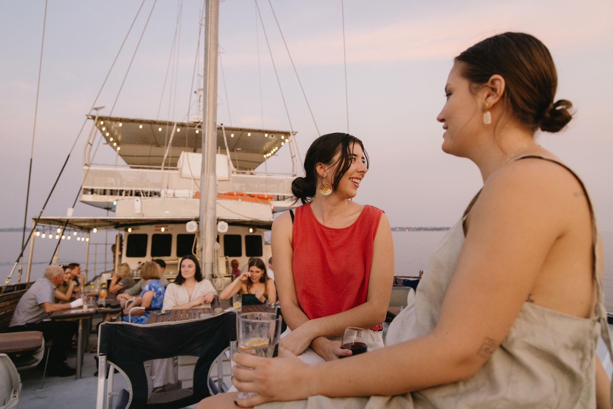 Guests gathered on deck for a sunset cruise aboard the Cape Adieu on Darwin Harbour
