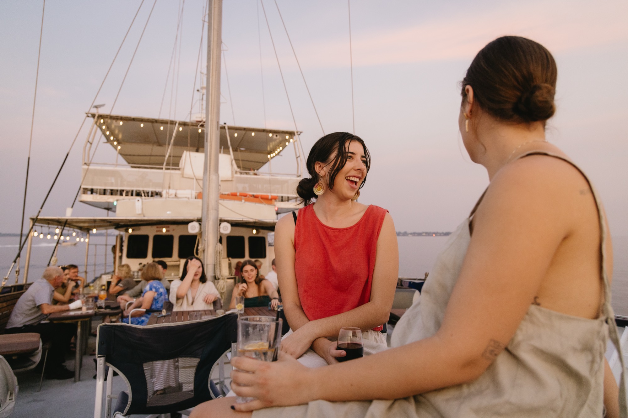 Colleagues sharing drinks and canapes on a Darwin Harbour cruise